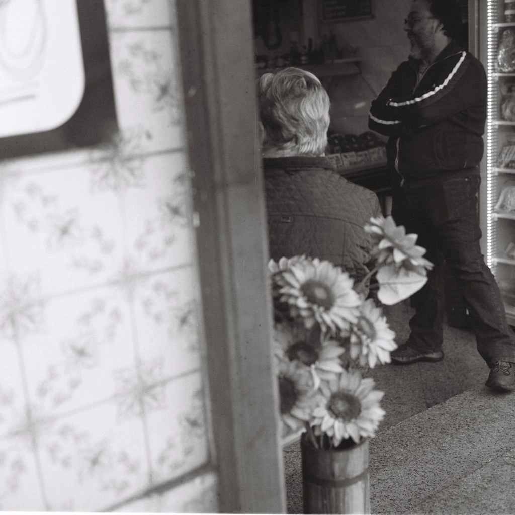A bodega owner on a Bronx street corner at dusk